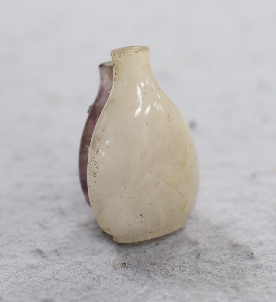 A 19th century Chinese quartz double snuff bottle, 6cm, the carver skilfully incorporating the amethyst crystal inclusions to the relief carving of the front bottle